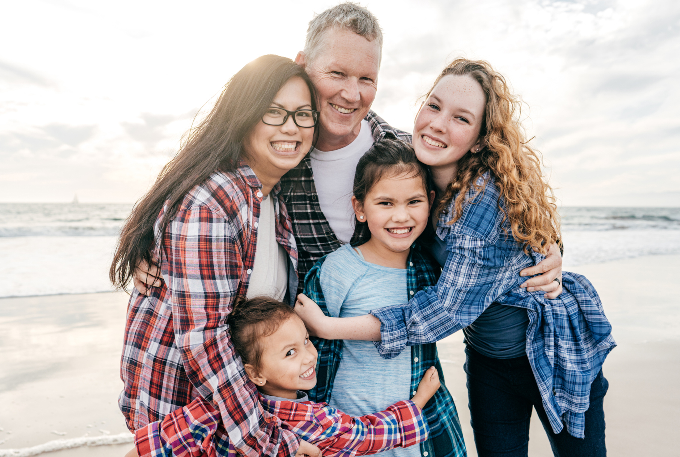 family photo together at the beach