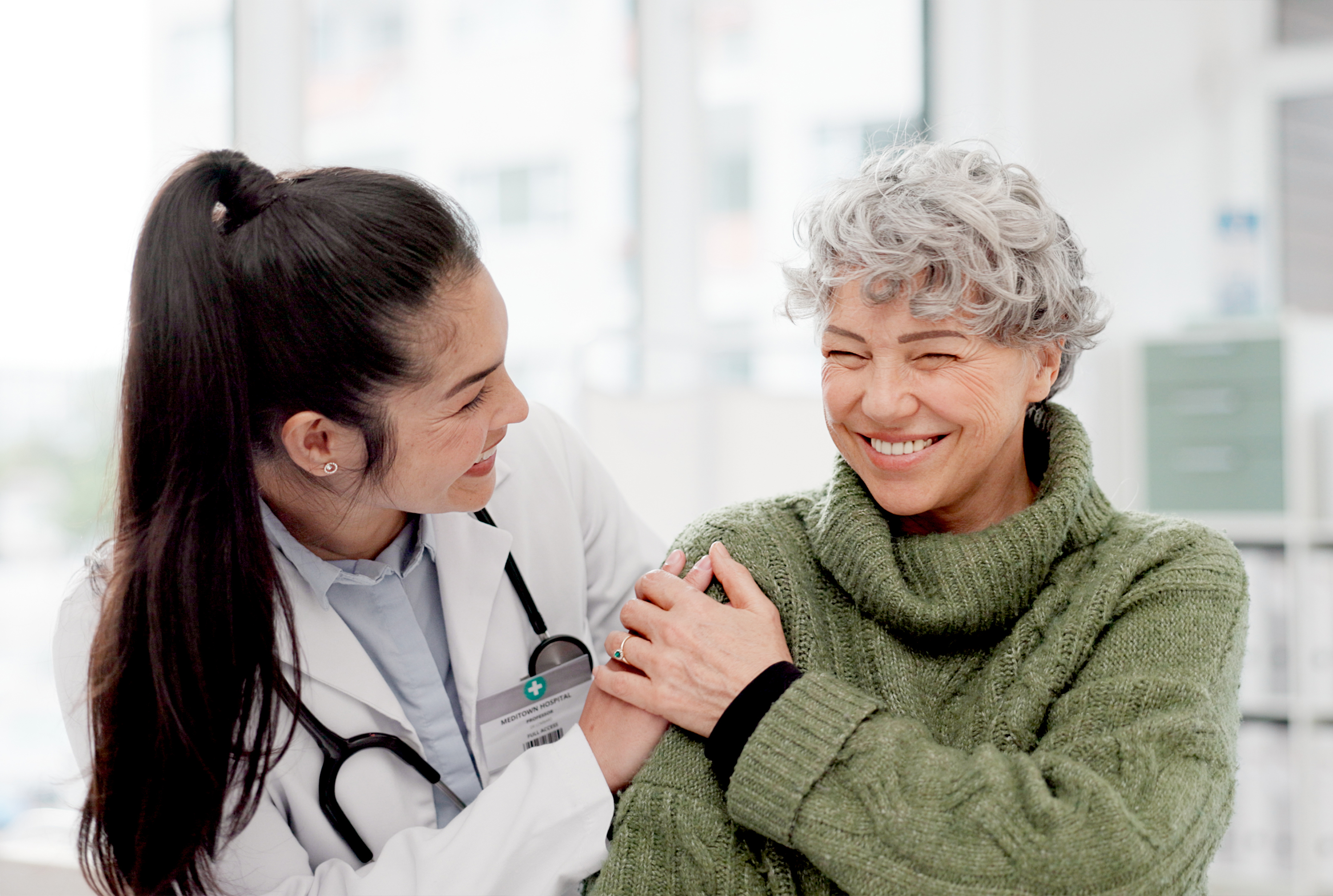 Doctor comforting an elderly woman
