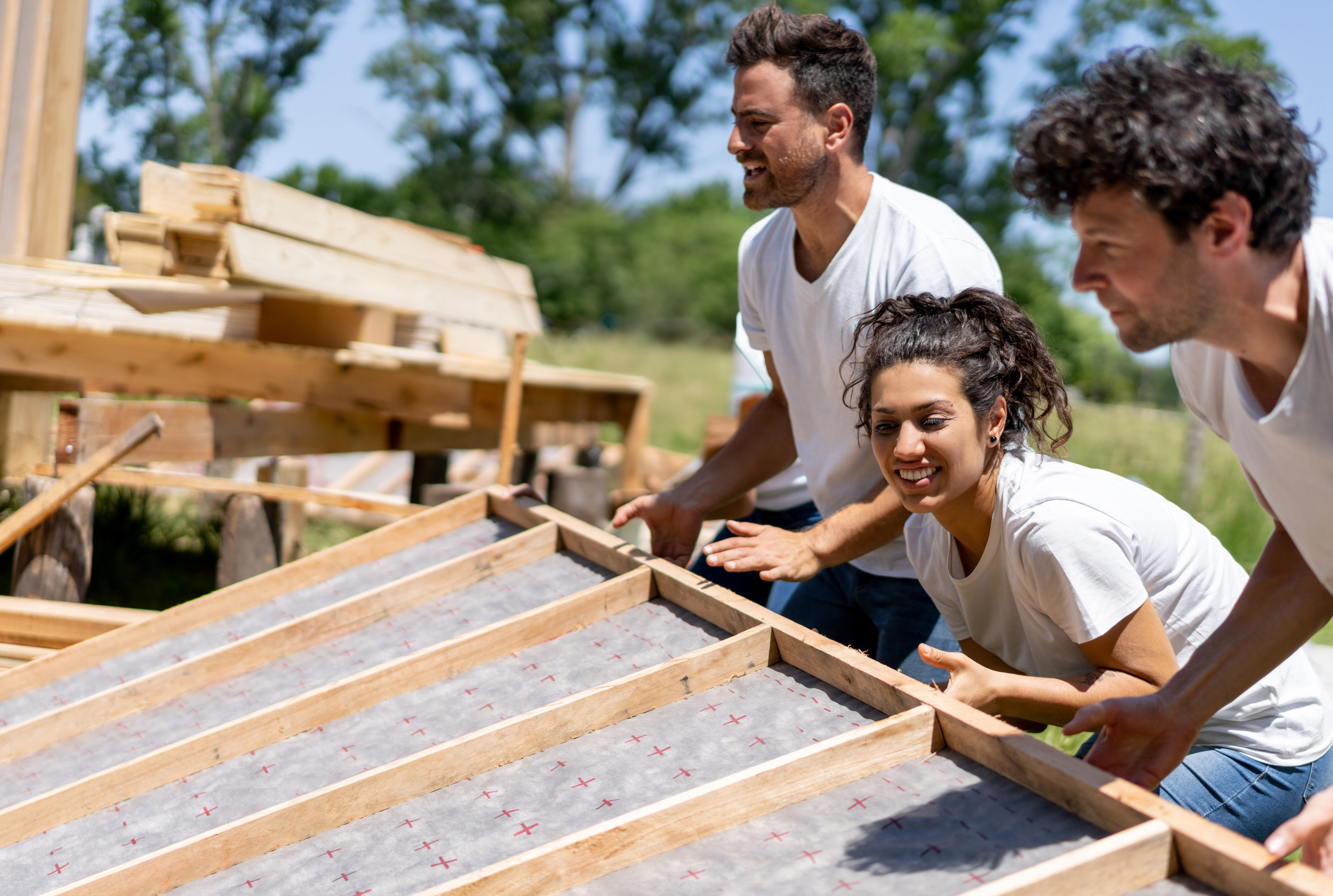 people framing a green house